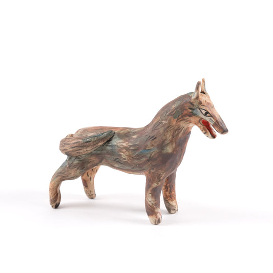 A painted ceramic wolf whistle in shades of brown and blue standing on a plain white background.