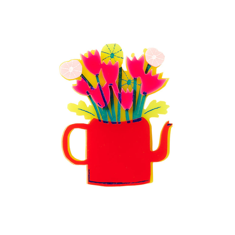 Red teapot brooch with colourful flowers coming out the top on a white background.