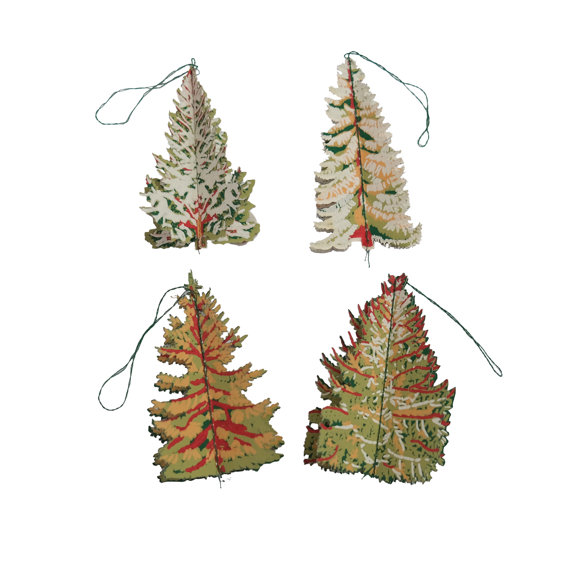 Four tree-shaped Christmas ornaments with autumnal colours on a white background