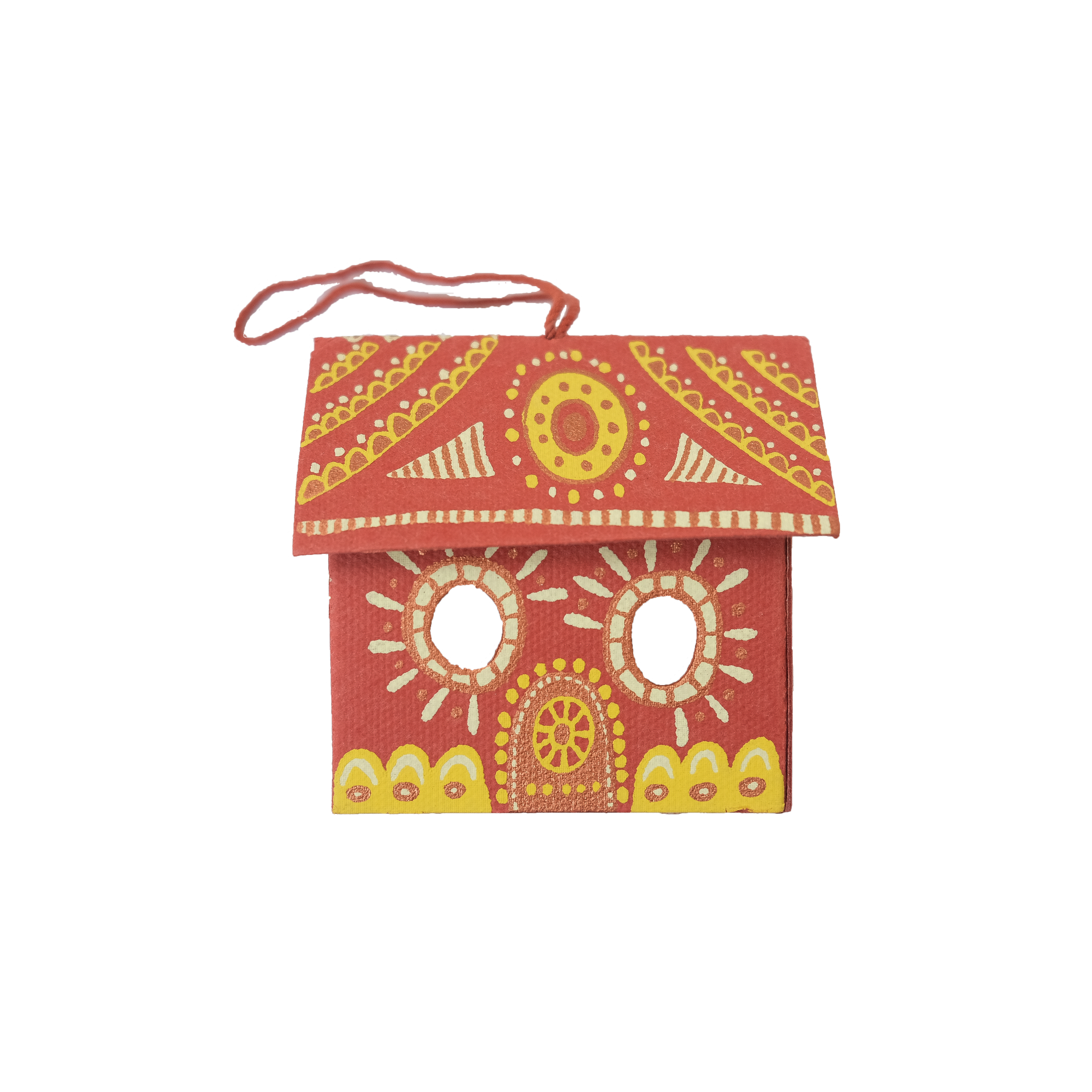 Decorative red gingerbread house decoration with yellow and white patterns on a white background