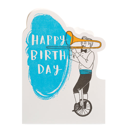 Card with a person on a unicycle playing a trombone and 'Happy Birthday' text.
