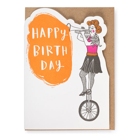 Birthday card with a women playing the trumpet on a unicycle and 'Happy Birthday' text