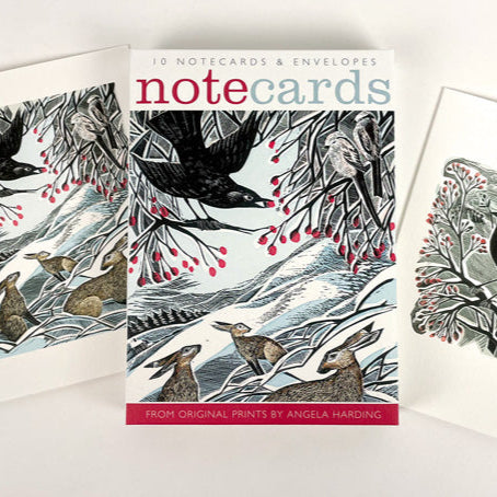 Set of notecards with animal illustrations on a white background. The main colours are red, white and black and there is a very wintery feel.