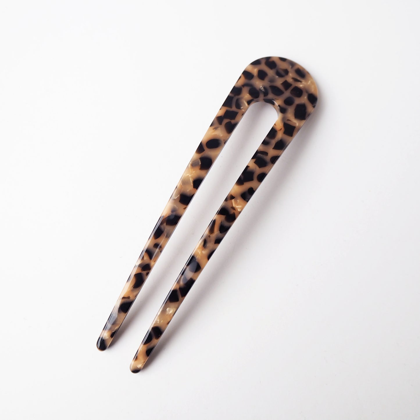 Leopard print hair clip on a white background