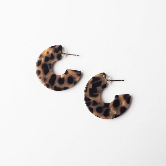 Leopard print hoop earrings on a white background