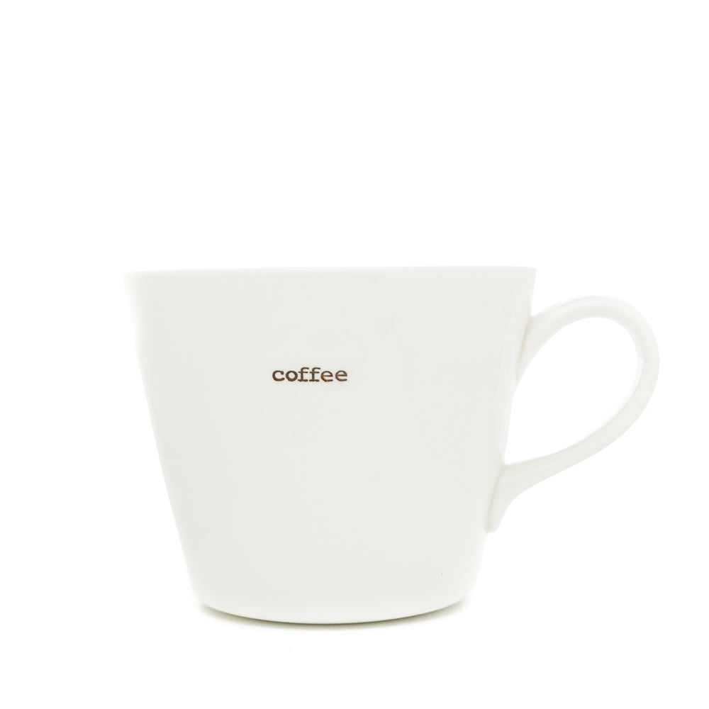 A white Keith Brymer Jones medium bucket mug with the word 'coffee' stamped in brown on the front.