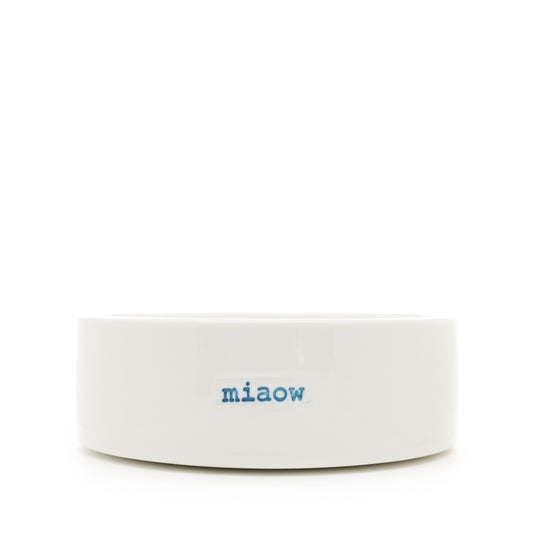A white ceramic pet bowl with 'MIAOW' hand-stamped in blue.