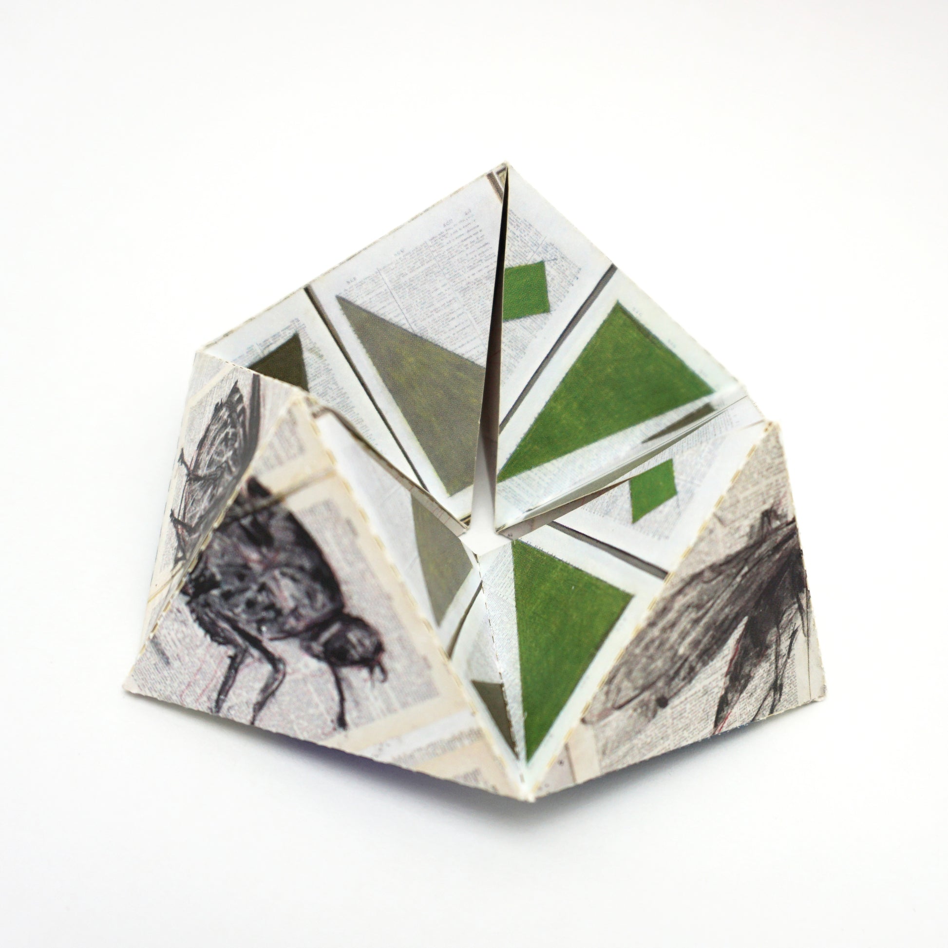 Geometric paper sculpture with geometric patterns on a white background