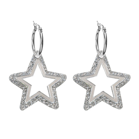 A pair of star shaped acrylic silver earrings on a silver hoop with silver glitter and a cut out middle.