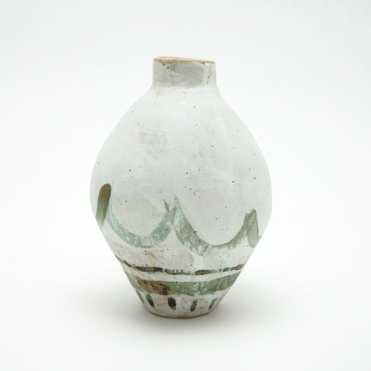 White ceramic oval vase with green and brown glazed accents on a white background. The green and brown glaze is painted on in swooping lines.