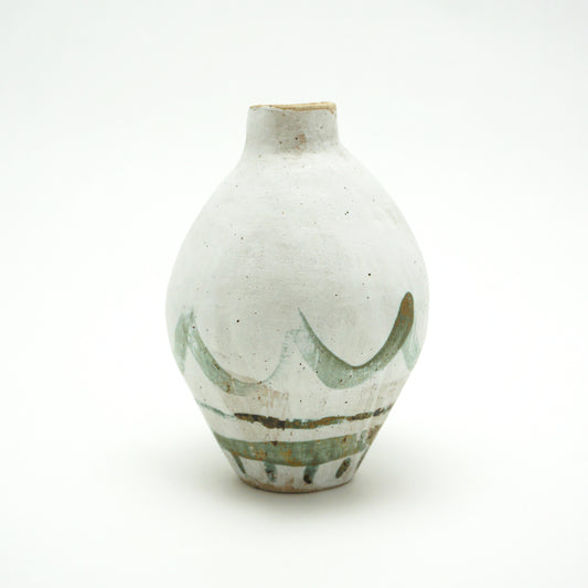 White ceramic oval vase with green and brown glazed accents on a white background. The green and brown glaze is painted on in swooping lines.