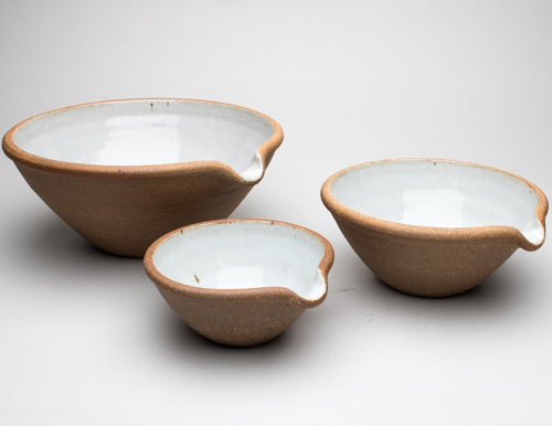 A set of three bowls arranged next to each other, featuring a pouring spout.