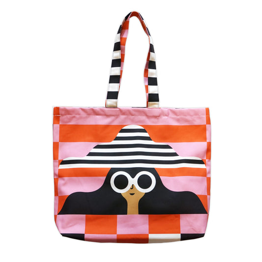 Tote bag featuring the head of a figure wearing large white sunglasses and a bit stripey hat, photographed on a plain white background.