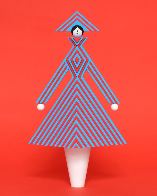 A colourful wooden sculpture with a red and blue stripey 3D top and skirt and a matching headdress with white legs on a plain orange background.