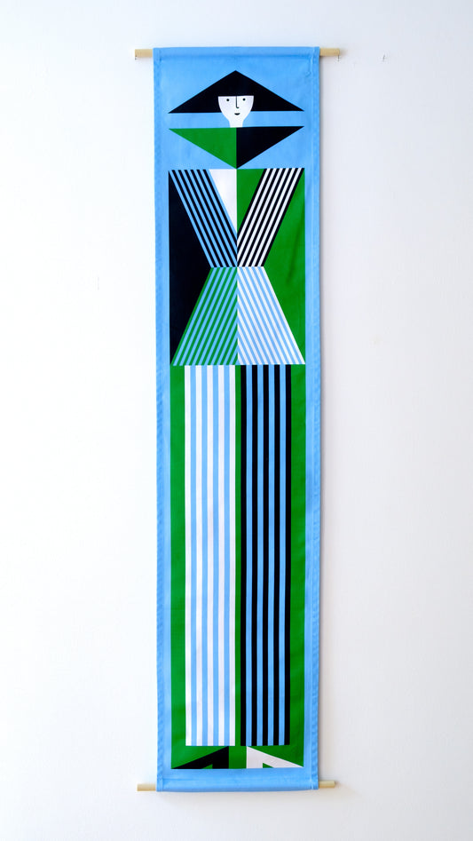 A fabric banner featuring a green and blue geometric figure with black and white accents. 