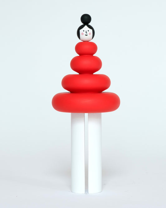 A red and white wooden figure, featuring a curved stacked body on a plain white background.