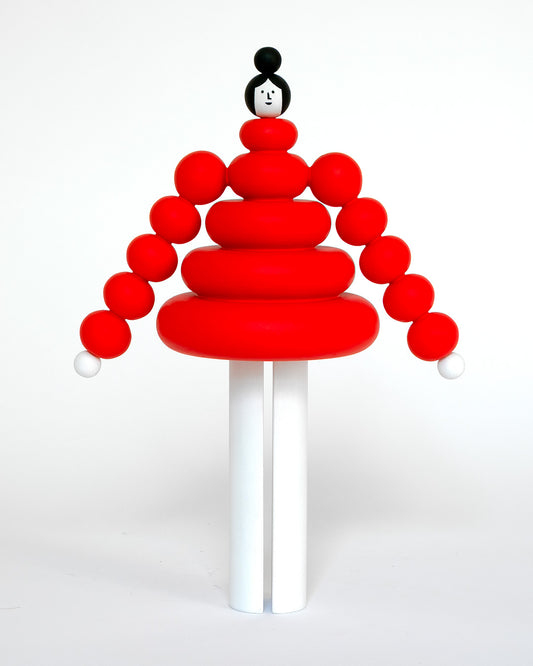 A red and white wooden figure, featuring a round bubble red stacked body and white legs on a plain white background.
