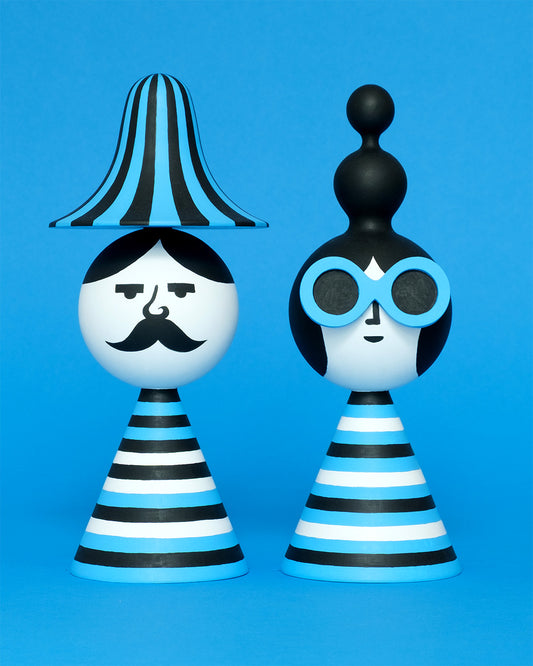 A pair of blue, white, and black stripey bust figures with a stripey hat and blue sunglasses on a plain blue background.