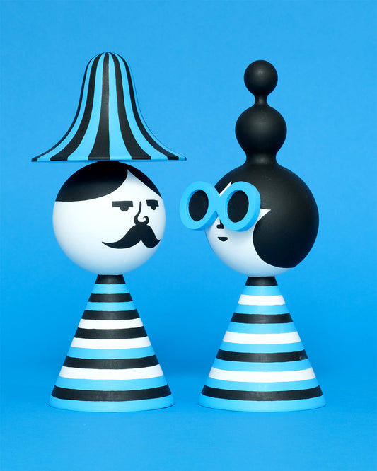 A pair of blue, white, and black stripey bust figures with a stripey hat and blue sunglasses on a plain blue background.