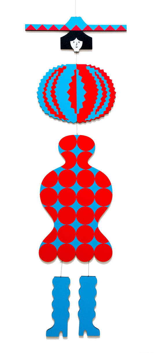 A hanging wooden colourful mobile featuring a full figure with a headdress and boots covered in bright geometric patterns.