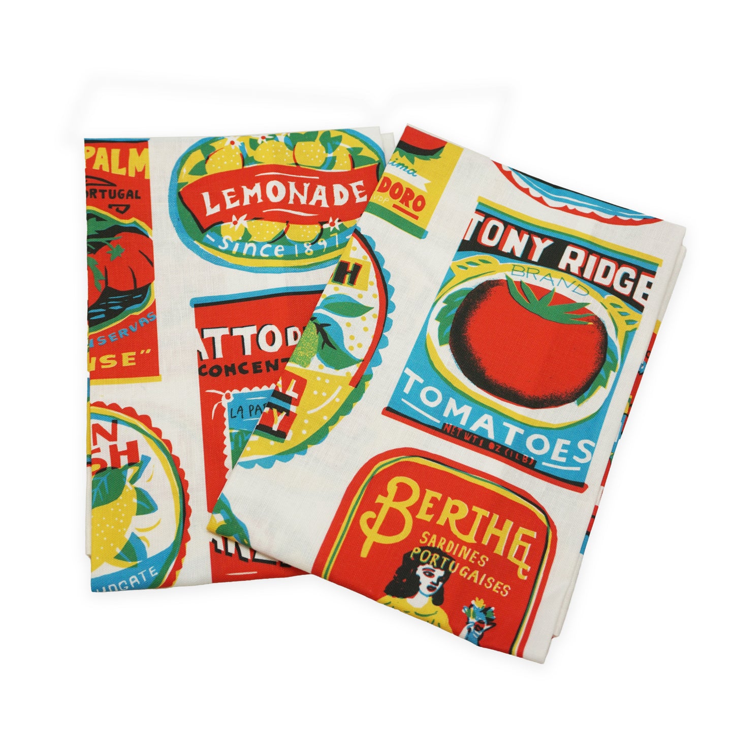 Two folded fabric tea towels featuring a vibrant print of vintage food labels, including lemonade, tomatoes, and sardines. The design showcases bright colours and retro typography, creating a cheerful and nostalgic aesthetic.