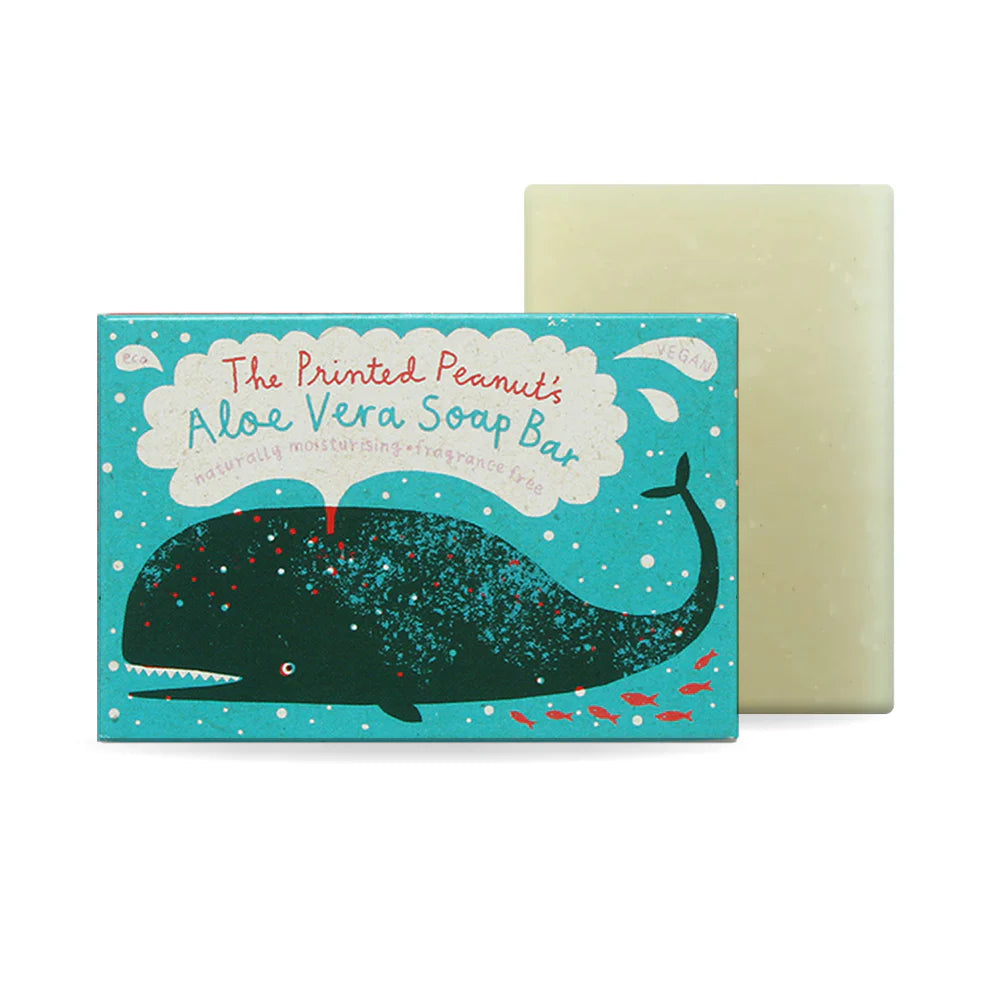 A vibrant packaging design featuring a cartoon whale and colourful fish, promoting "The Printed Peanut's Aloe Vera Soap Bar." The soap bar is light green and vegan, placed behind the illustrated box, which has a playful, ocean-themed aesthetic.