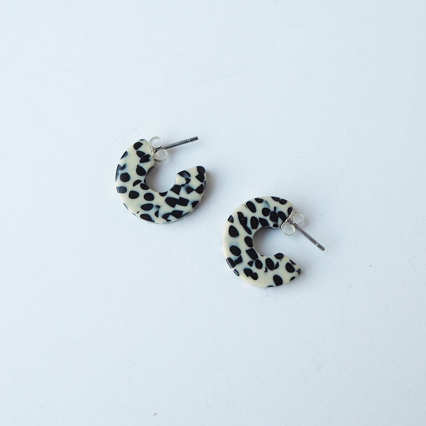 Pair of dalmatian print hoop earrings on a white background