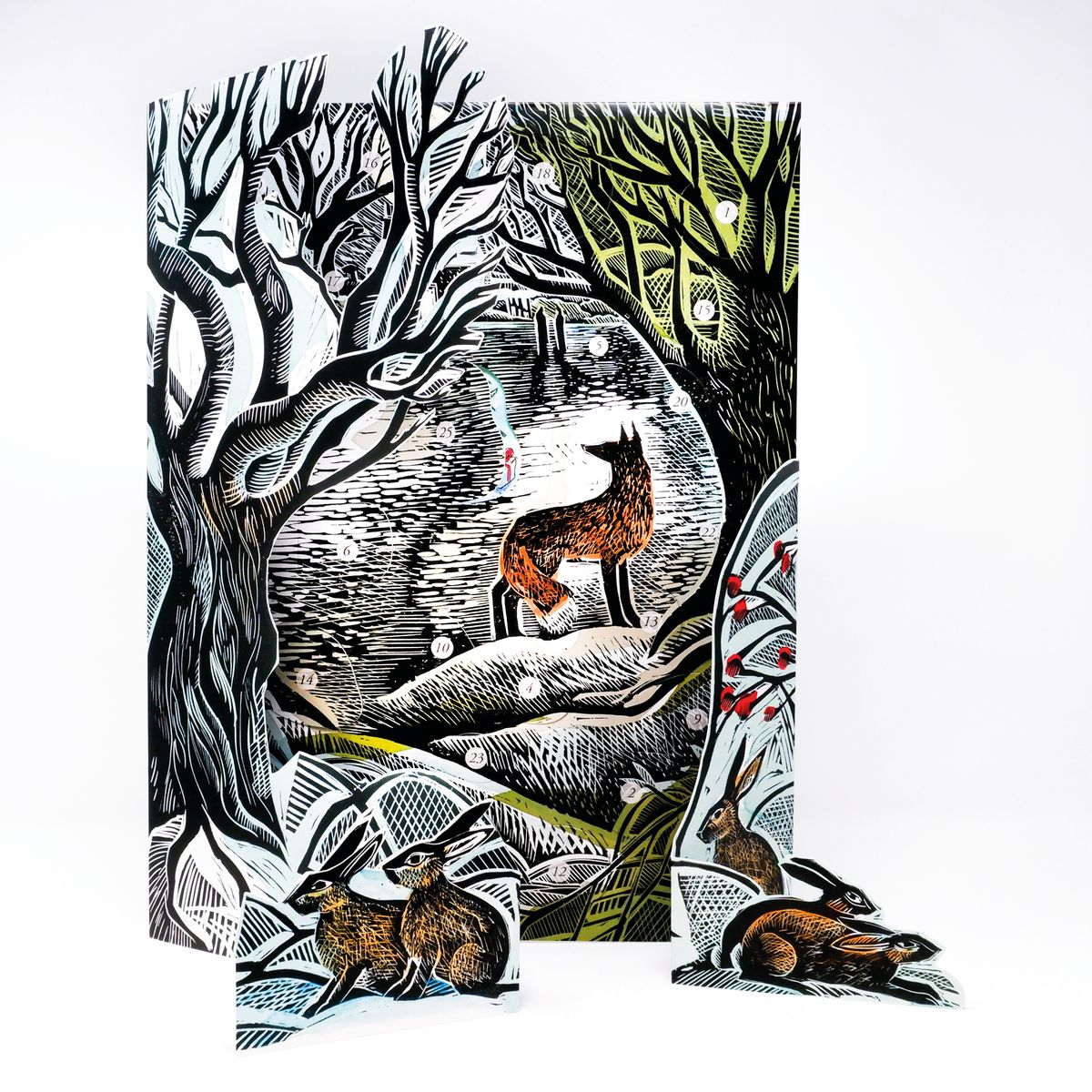 A decorative advent calendar featuring a woodland scene with a fox and several hares, shown standing upright with matching cutout pieces placed in front on a white background.