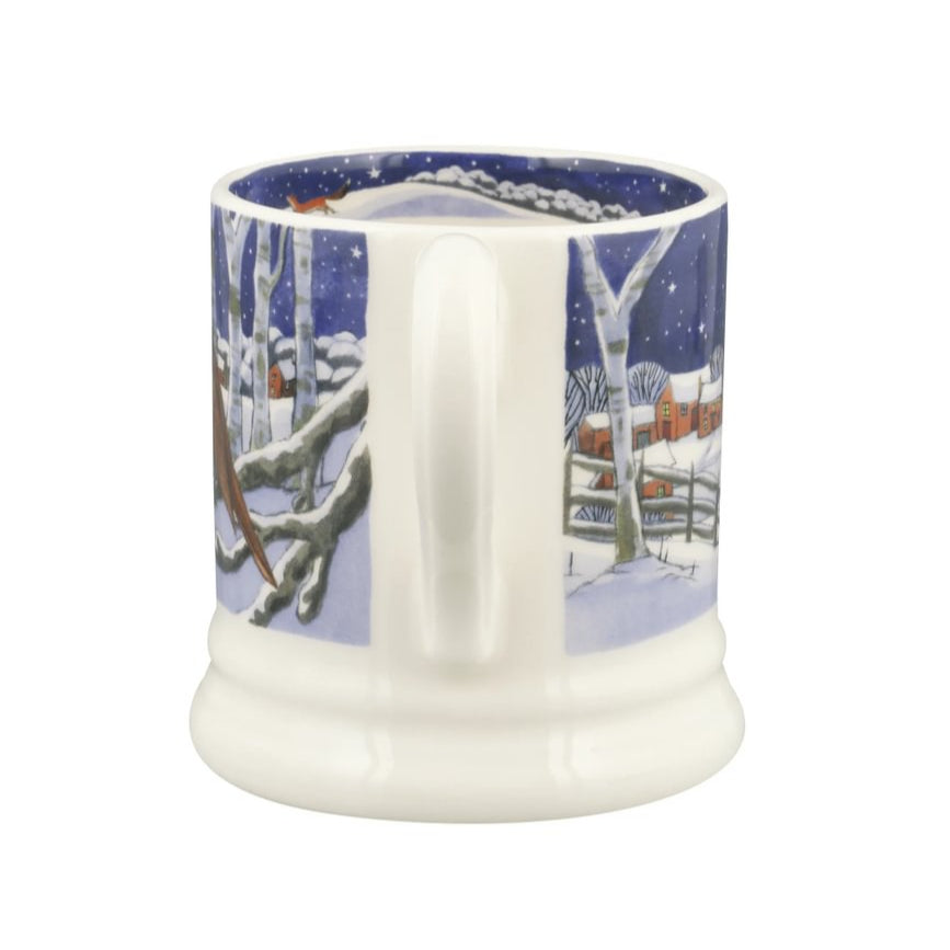 White mug with a winter scene design on a white background