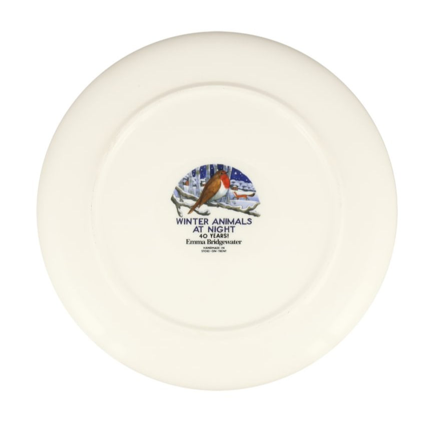 Underside of a white ceramic plate with a decorative design of a robin and text on a white background