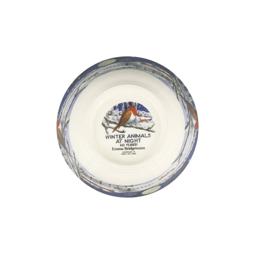 bottom of a ceramic bowl featuring text and a wintery image of a robin