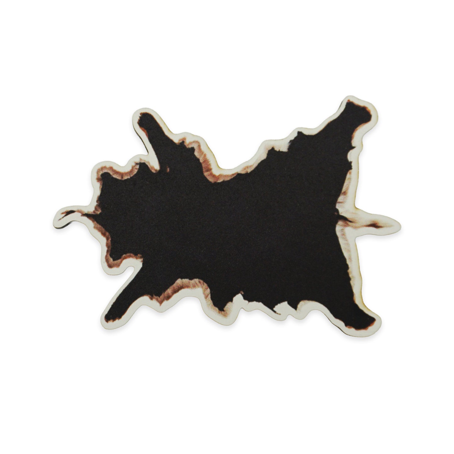 Abstract black shape with irregular, jagged edges and a brownish outline, resembling a cow hide. The background is plain white, highlighting the contrast and unique form of the shape.