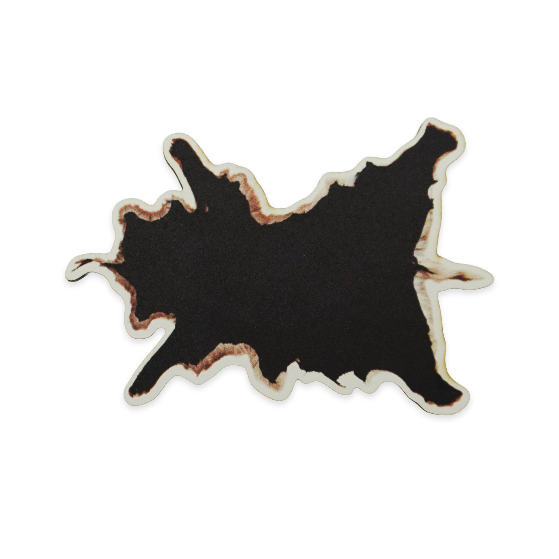Abstract black shape with irregular, jagged edges and a brownish outline, resembling a cow hide. The background is plain white, highlighting the contrast and unique form of the shape.