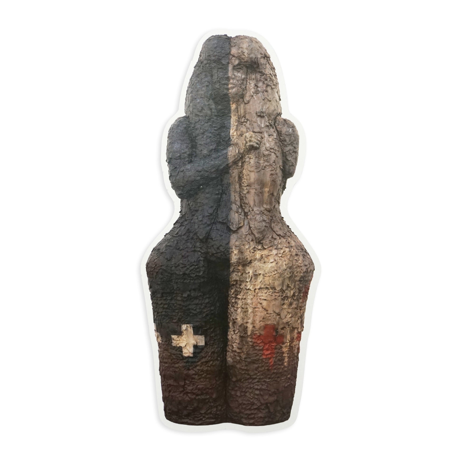 A small, abstract sculpture with a textured surface, featuring a dark brown and beige colour scheme. The sculpture has a cross symbol on the lower left side and a red mark on the lower right side, set against a plain white background.