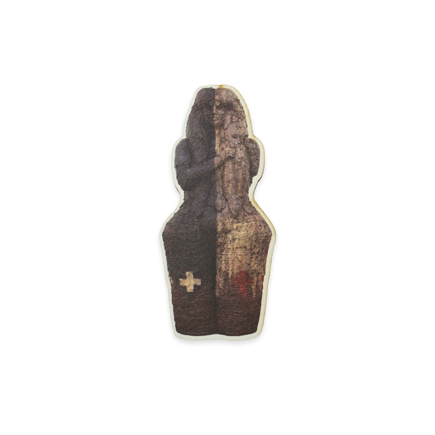 A small, abstract sculpture with a textured surface, featuring a dark brown and beige colour scheme. The sculpture has a cross symbol on the lower left side and a red mark on the lower right side, set against a plain white background.