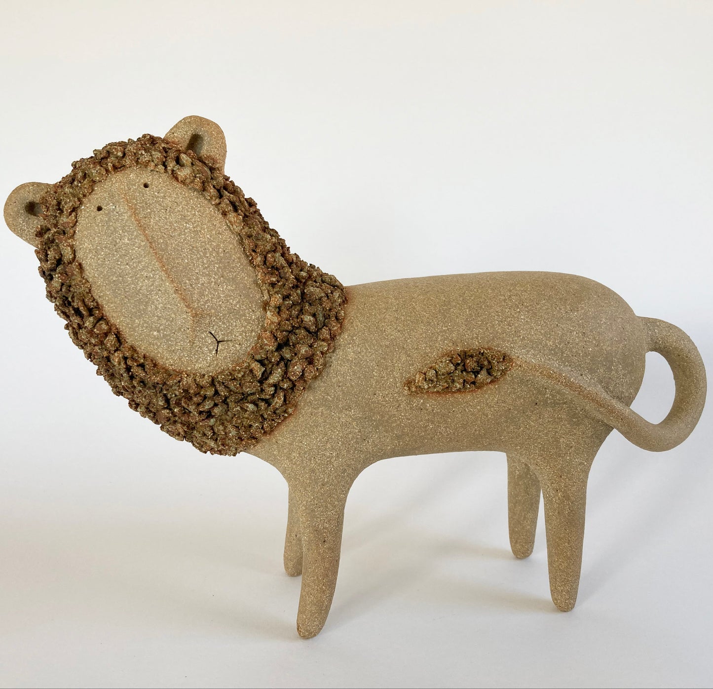 Ceramic lion sculpture on a white background