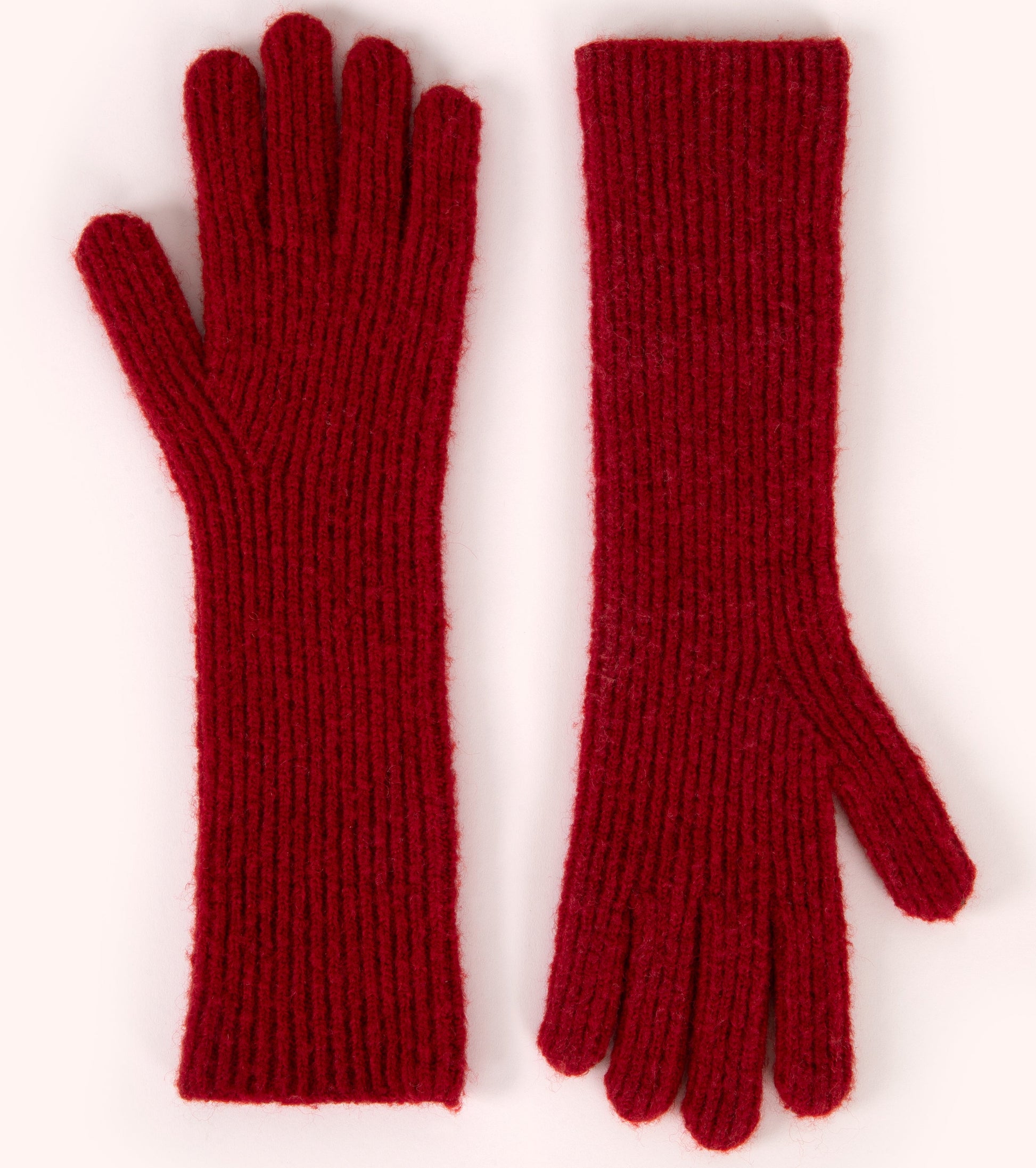 Pair of red knitted gloves on a white background