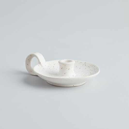 A white speckled ceramic mini candle holder with a handle, displayed against a plain background.