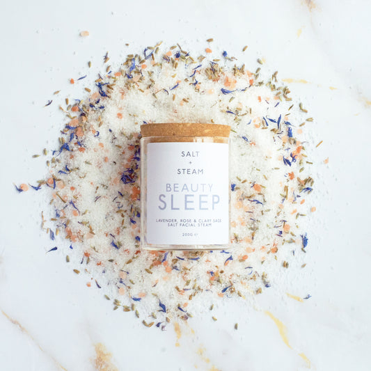 Salt and steam beauty sleep product surrounded by decorative salt crystals on a white background