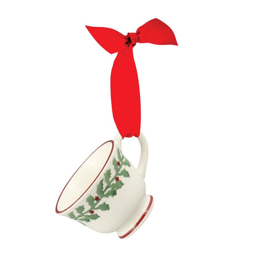 Teacup ornament with red ribbon on a white background