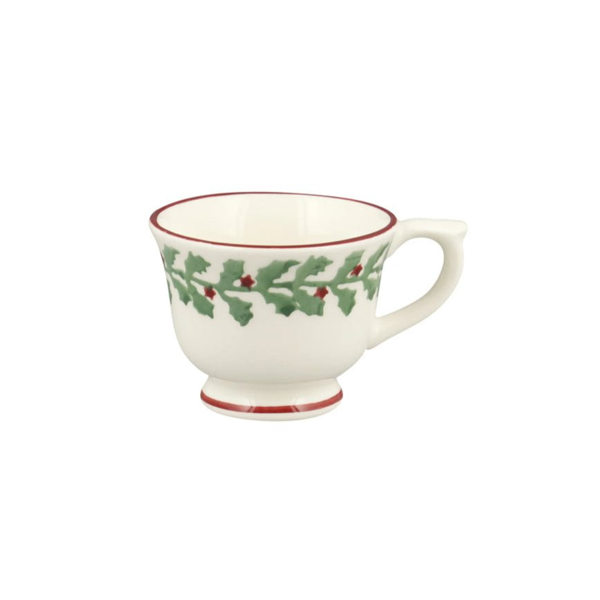 White mug with red rim and holly design on a white background