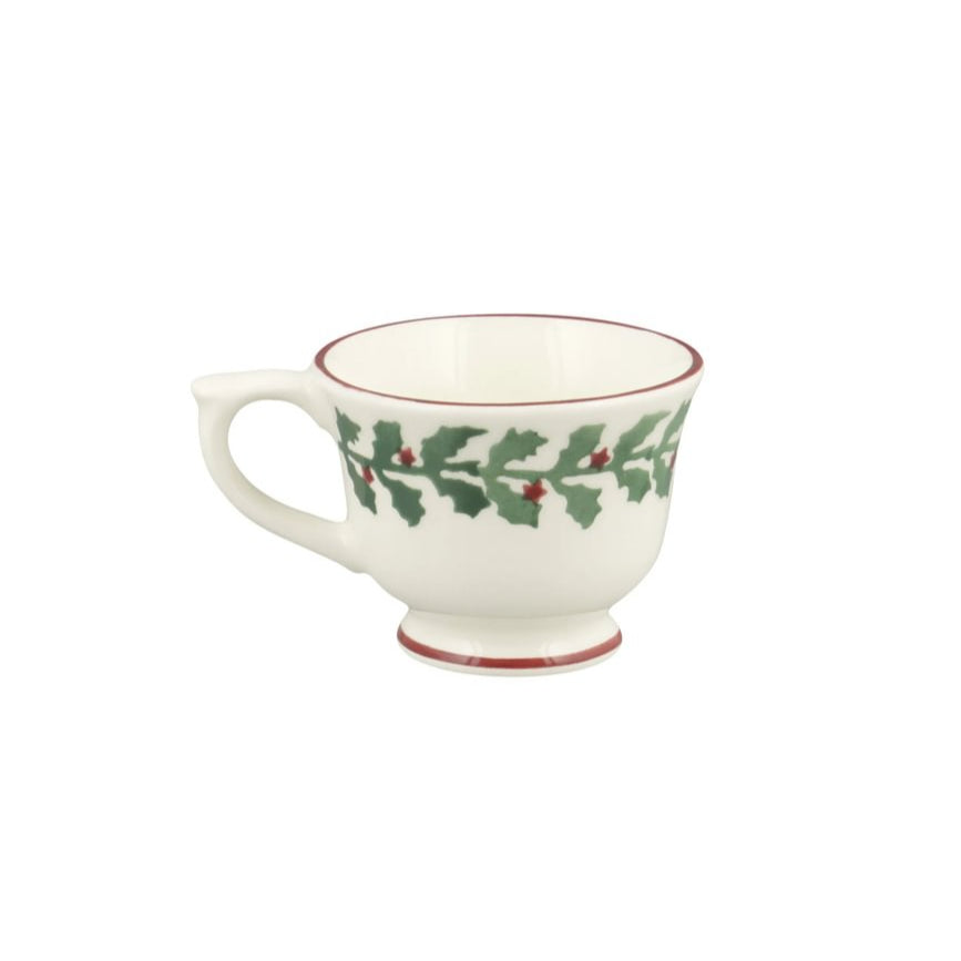 White mug with holly design on a white background