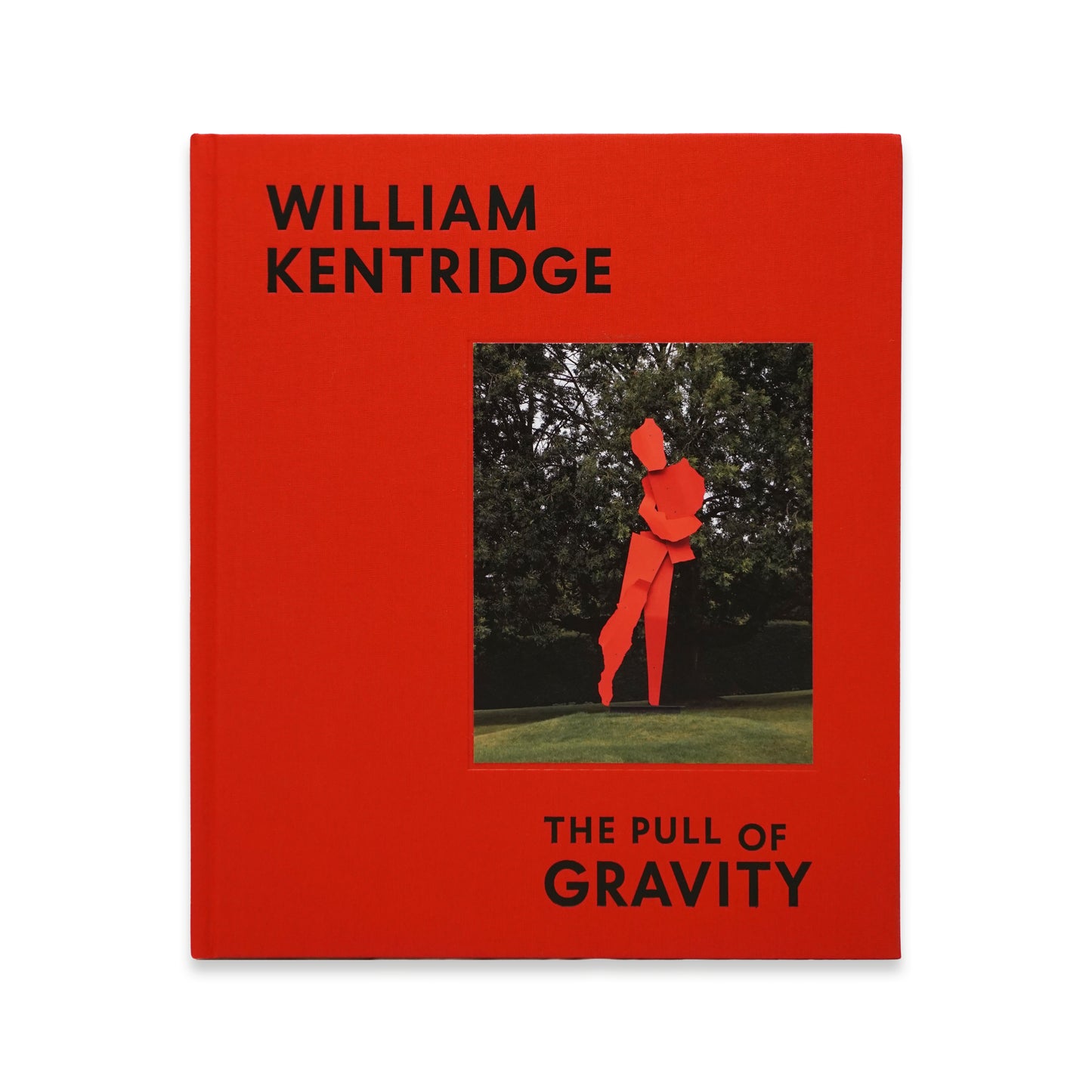 A bright red book cover featuring the title "William Kentridge: The Pull of Gravity" in bold black letters. The cover displays a striking image of a sculpture set against a green background, adding a vibrant contrast to the design.