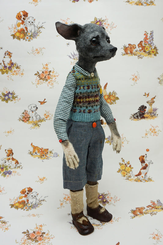 A whimsical, anthropomorphic dog figure stands upright, dressed in a checked shirt, patterned vest, and denim shorts. The background features a vintage-style wallpaper with illustrations of playful dogs and floral motifs.