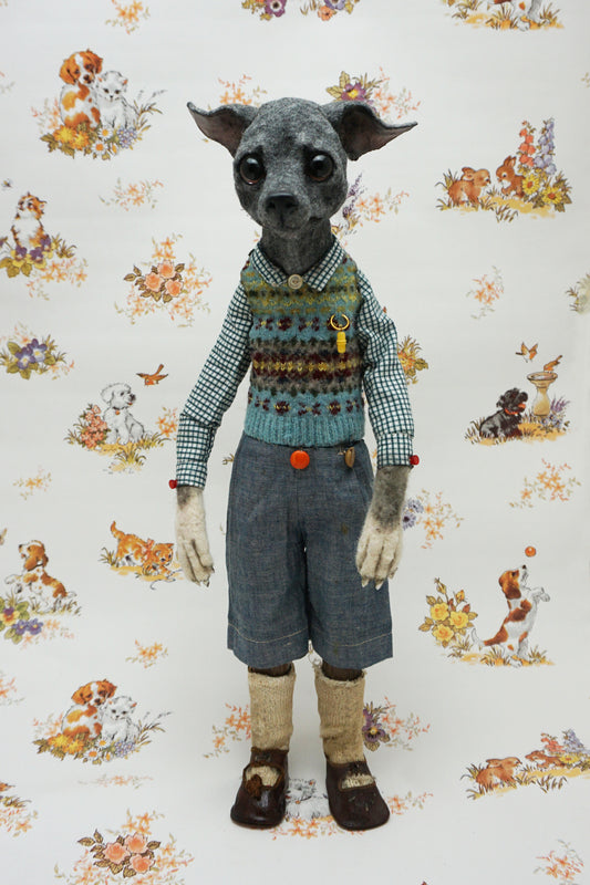 A whimsical, anthropomorphic dog figure stands upright, dressed in a checked shirt, patterned vest, and denim shorts. The background features a vintage-style wallpaper with illustrations of playful dogs and floral motifs.