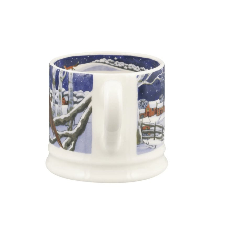 Ceramic mug with a winter scene design on a white background