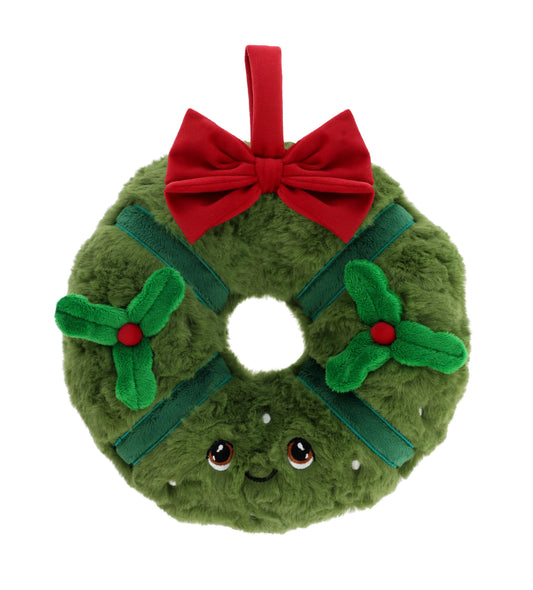 Plush toy shaped like a Christmas wreath with a red bow on a white background