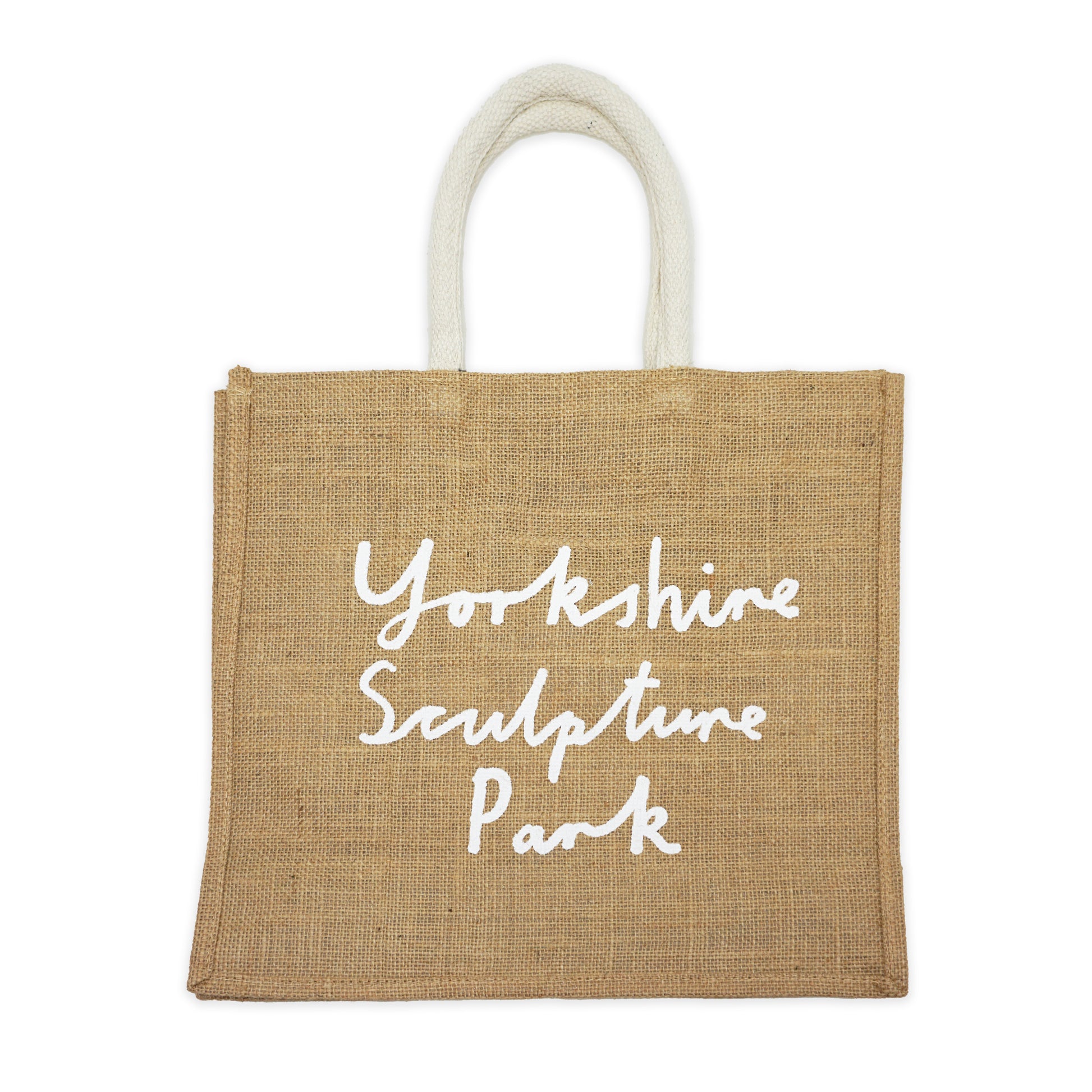 Beige jute bag with printed 'Yorkshire Sculpture Park' hand-written text in white on a plain white background