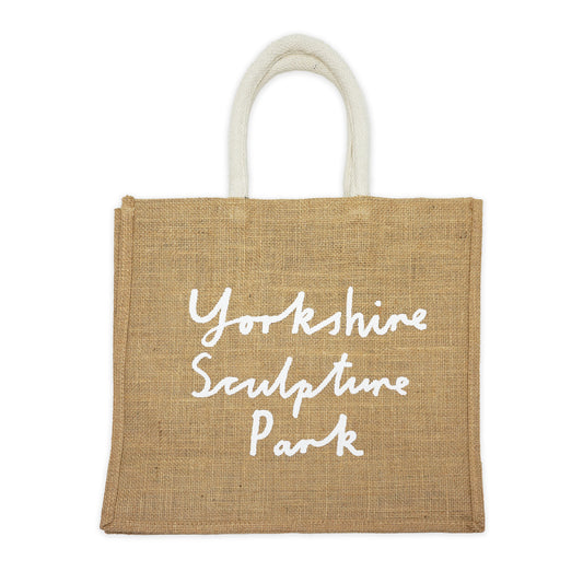 Beige jute bag with printed 'Yorkshire Sculpture Park' hand-written text in white on a plain white background