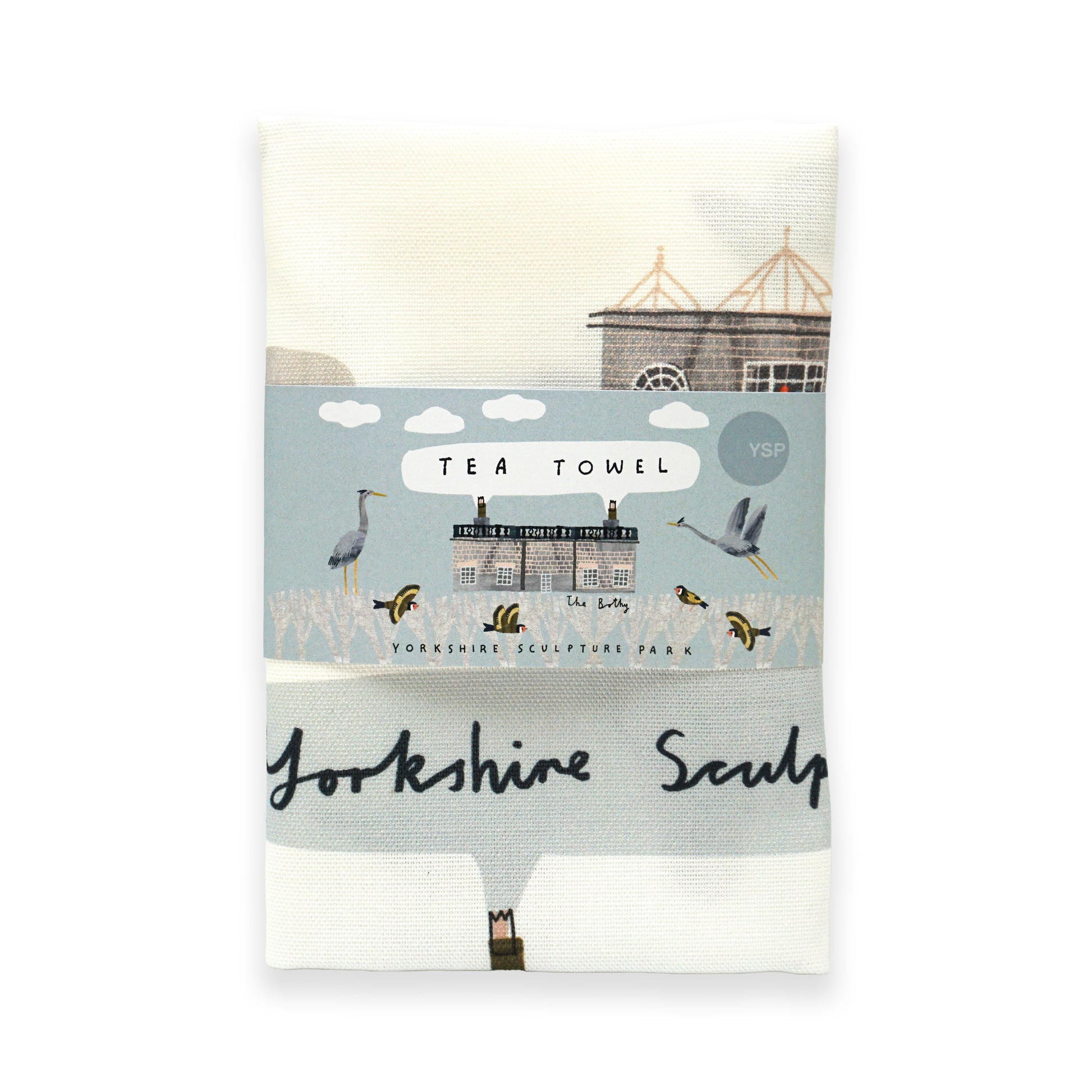 A folded tea towel featuring a design inspired by Yorkshire Sculpture Park. The towel is wrapped in a decorative band that includes the text "Tea Towel" and "Yorkshire Sculpture" alongside illustrations of birds and a building.